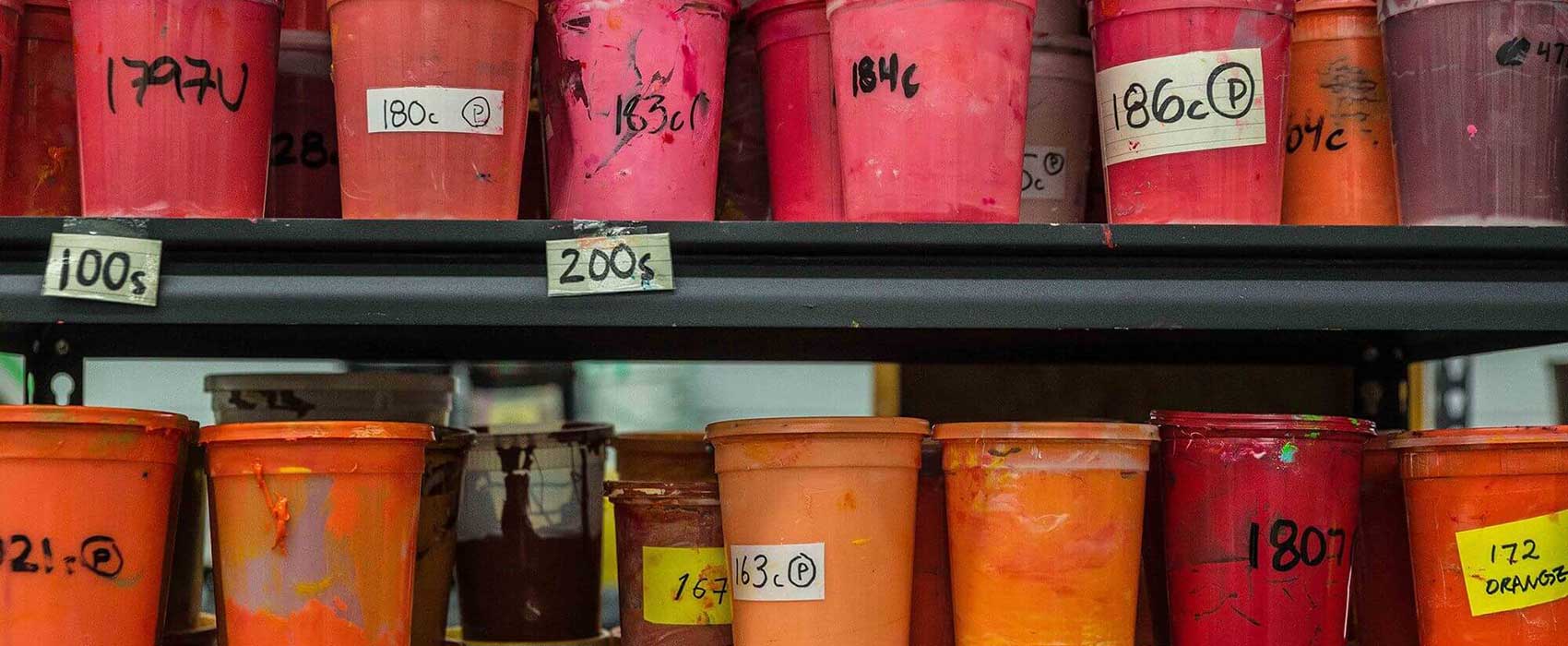 Rows of colorful screen printing ink containers